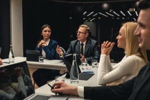 The business people at the meeting.